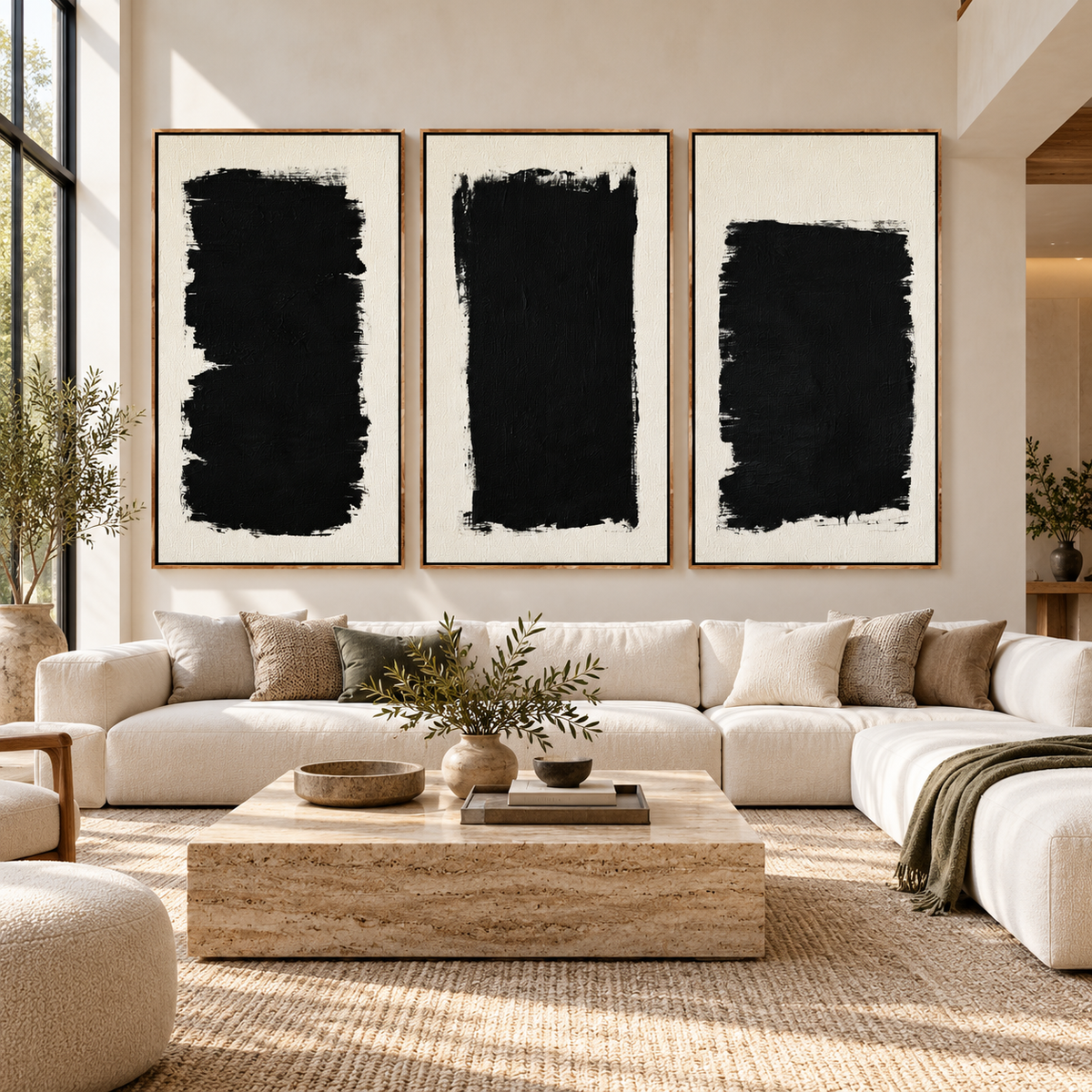 3 Piece Abstract Wall Art Set – Black Monoliths above a cream sectional sofa in a living room by Rossetti Art