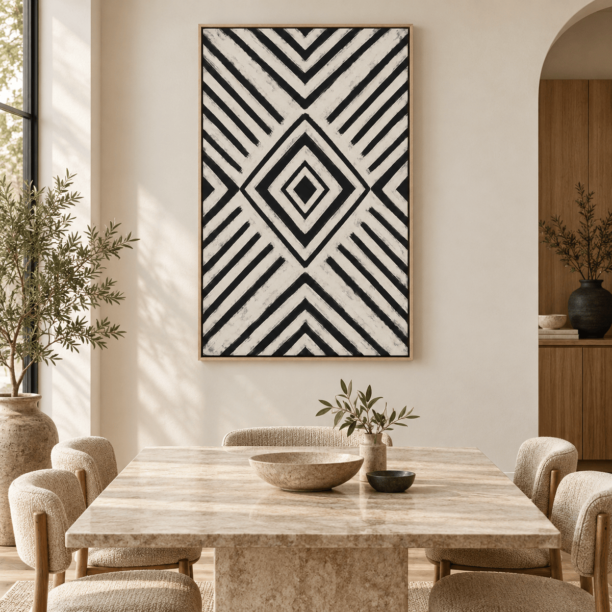 Oversized black and white geometric canvas art in an oak floater frame displayed in a modern living room