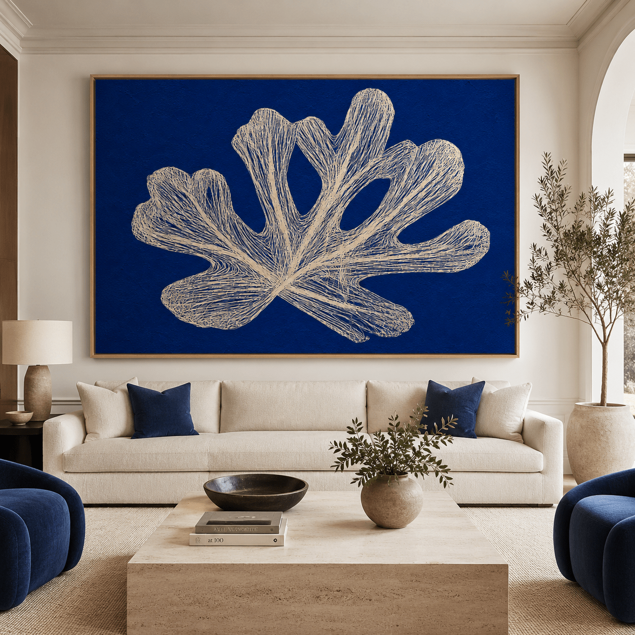 Blue botanical wall art canvas print displayed above a sofa in a living room