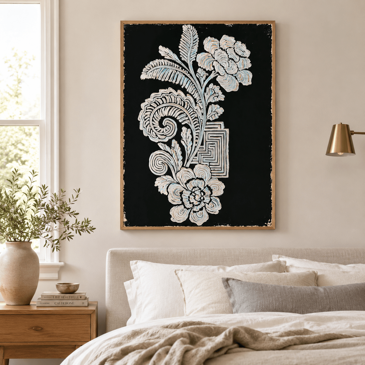 Black and white botanical wall art canvas print displayed above a bed in a neutral bedroom