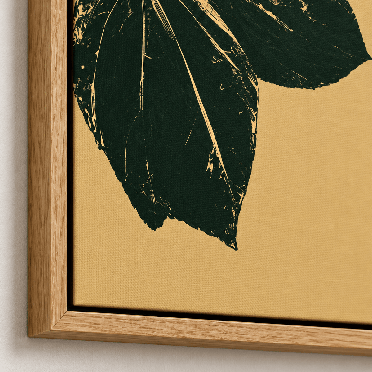 Close-up of the Gilded Foliage leaf wall art canvas print corner showing a dark green leaf and the fine canvas texture