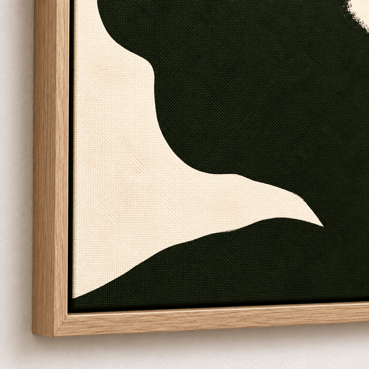 Close-up of the Quiet Profile canvas print corner showing the cream shoulder line and the fine canvas texture