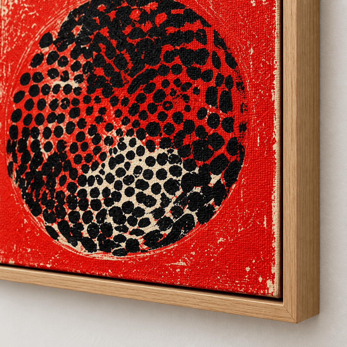 Close-up of the textured black and cream dotted print on red and oak floater frame corner on Ember Halo canvas print