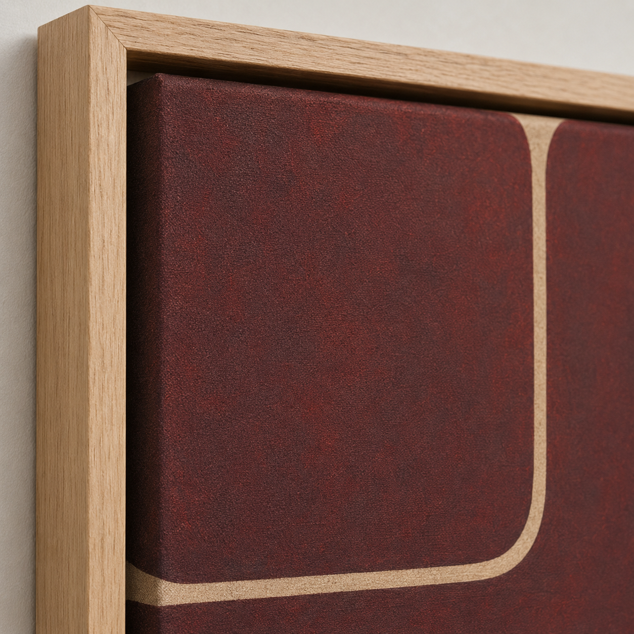Close-up of the oak floater frame and textured canvas on Quiet Divide, a burgundy wall art canvas print by Rossetti Art