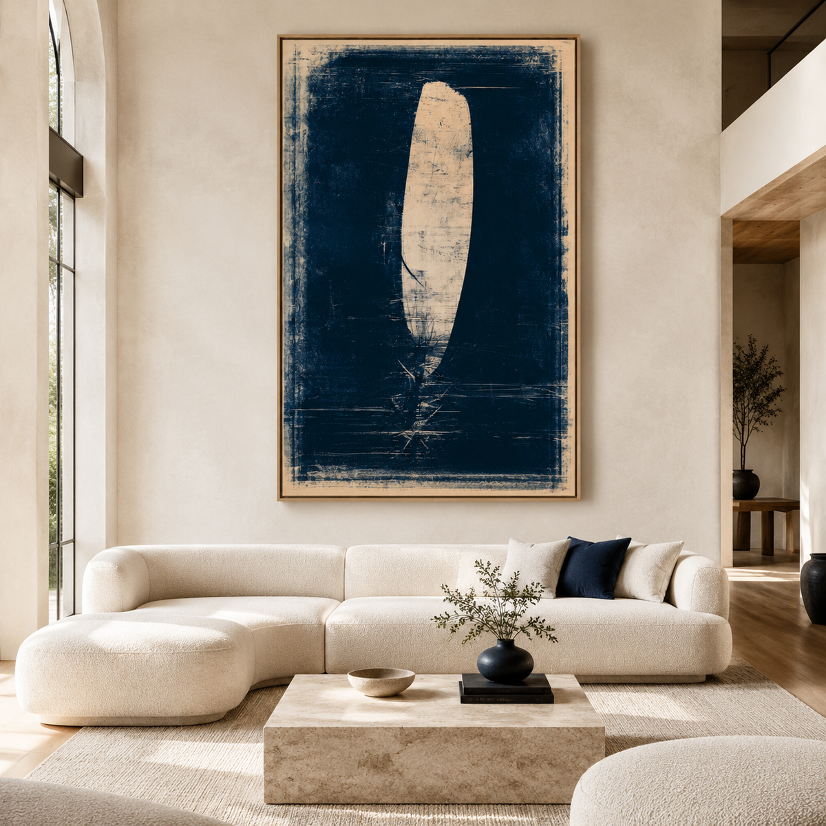 Feather painting in navy and cream displayed above a sofa in a modern living room