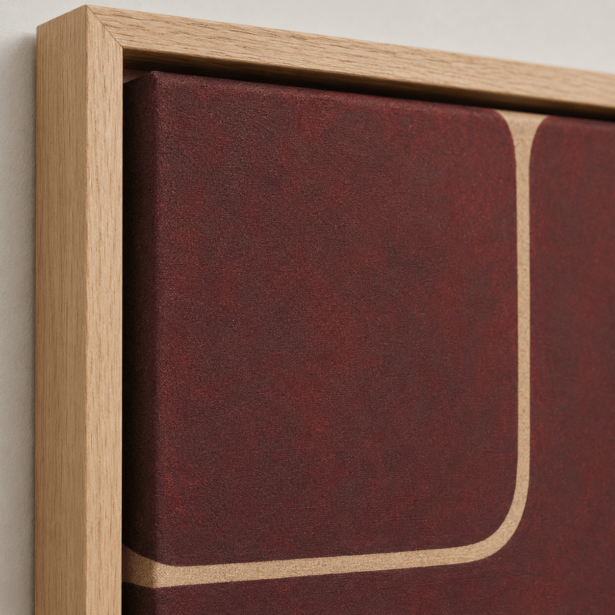 Close-up of the oak floater frame and textured canvas on Quiet Divide, a burgundy wall art canvas print by Rossetti Art