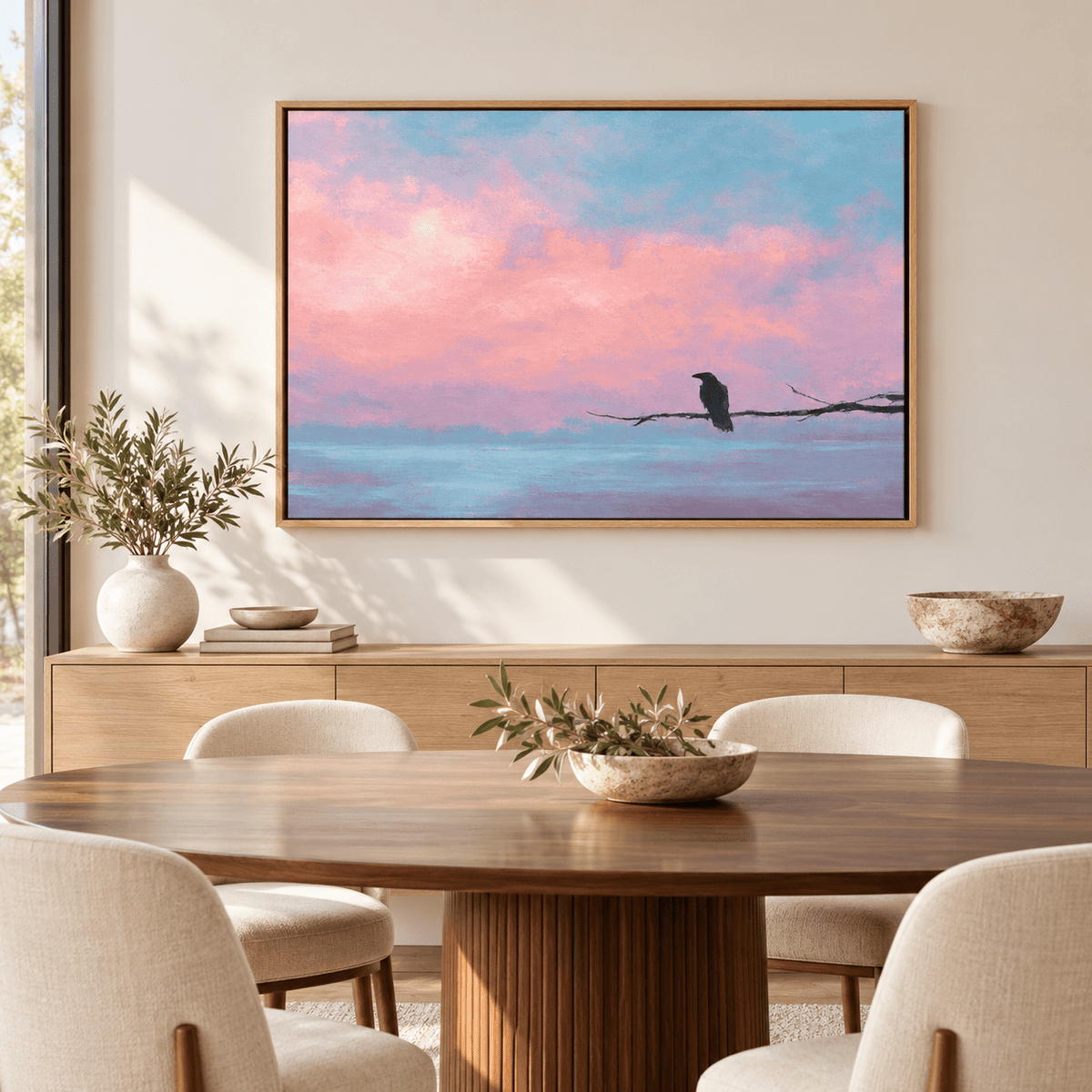 Pink sky raven wall art Quiet Perch above a wooden sideboard in a dining room