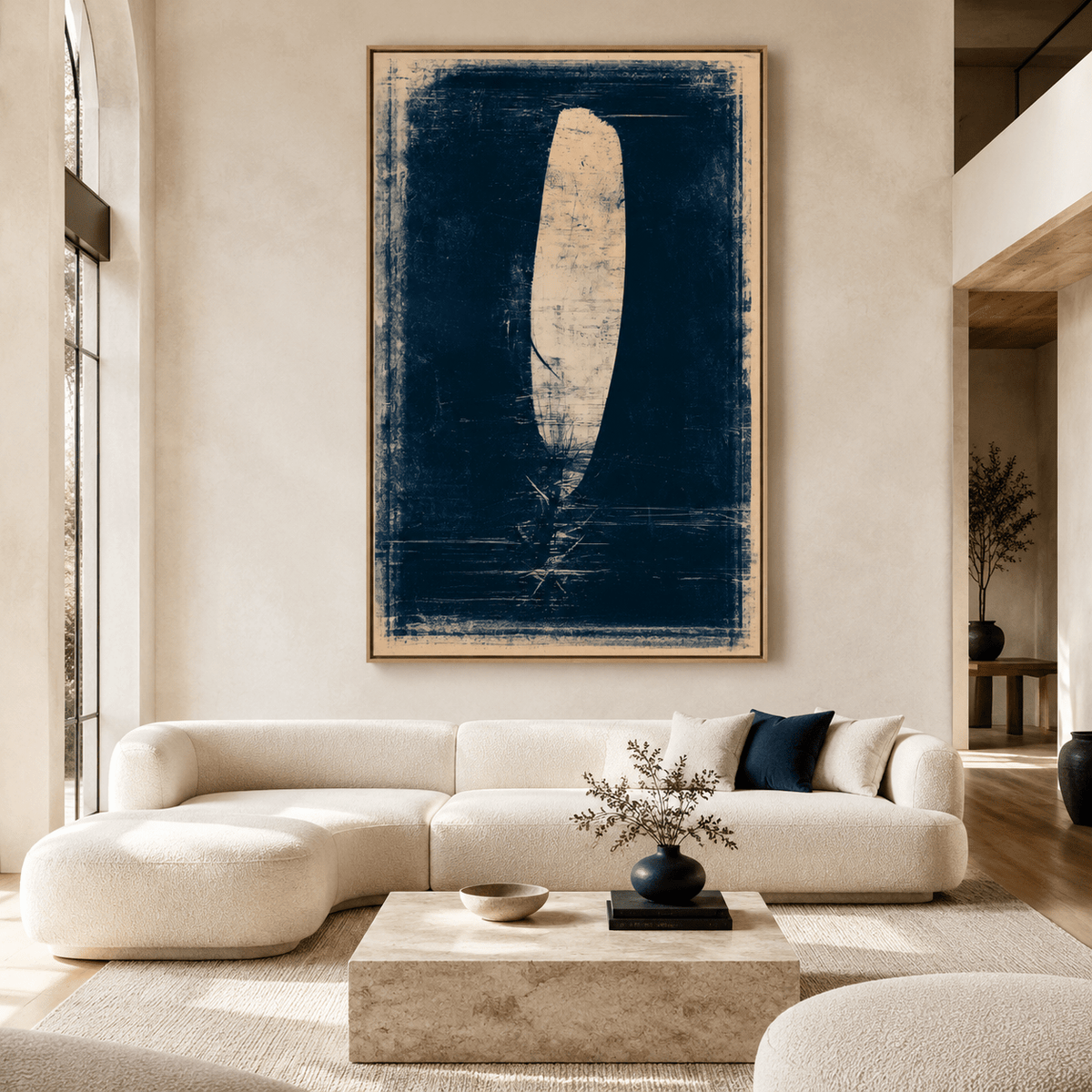 Feather painting in navy and cream displayed above a sofa in a modern living room