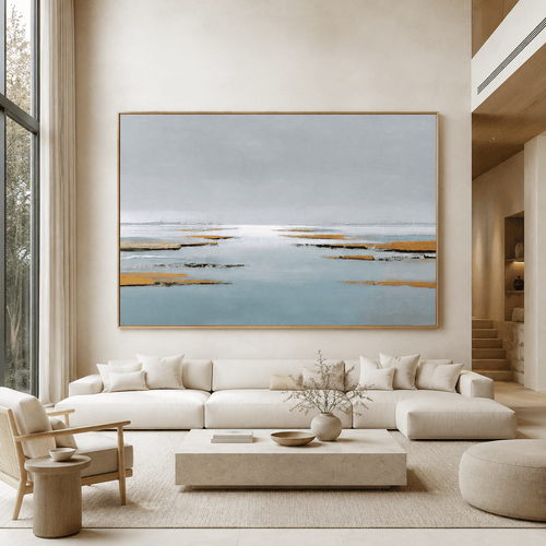 Gray and tan wall art canvas print above a sofa in a bright living room with a staircase – Low Water by Rossetti Art