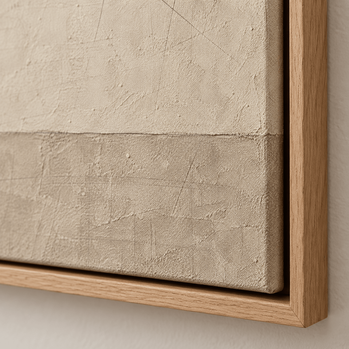 Close-up detail of neutral beige painted texture, canvas surface and natural oak floater frame